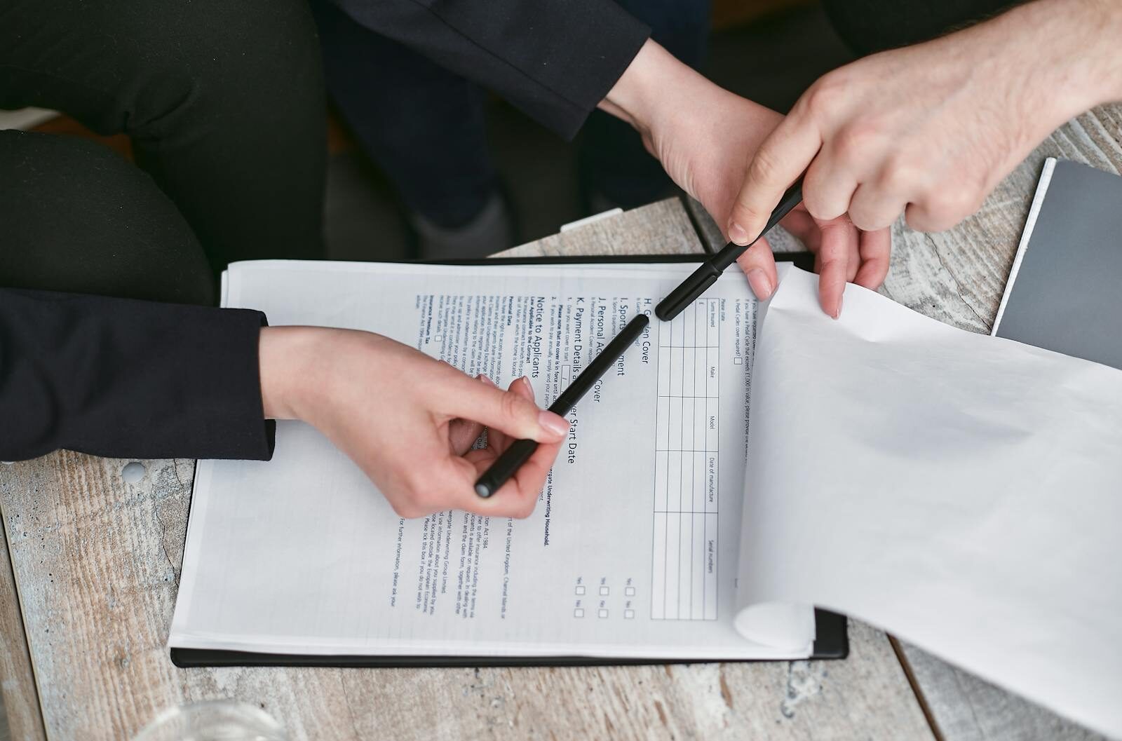 business decision, contract signing 📸📸 Realistic photo of two professionals reviewing contract documents before signing, office environment, natural light Business decision